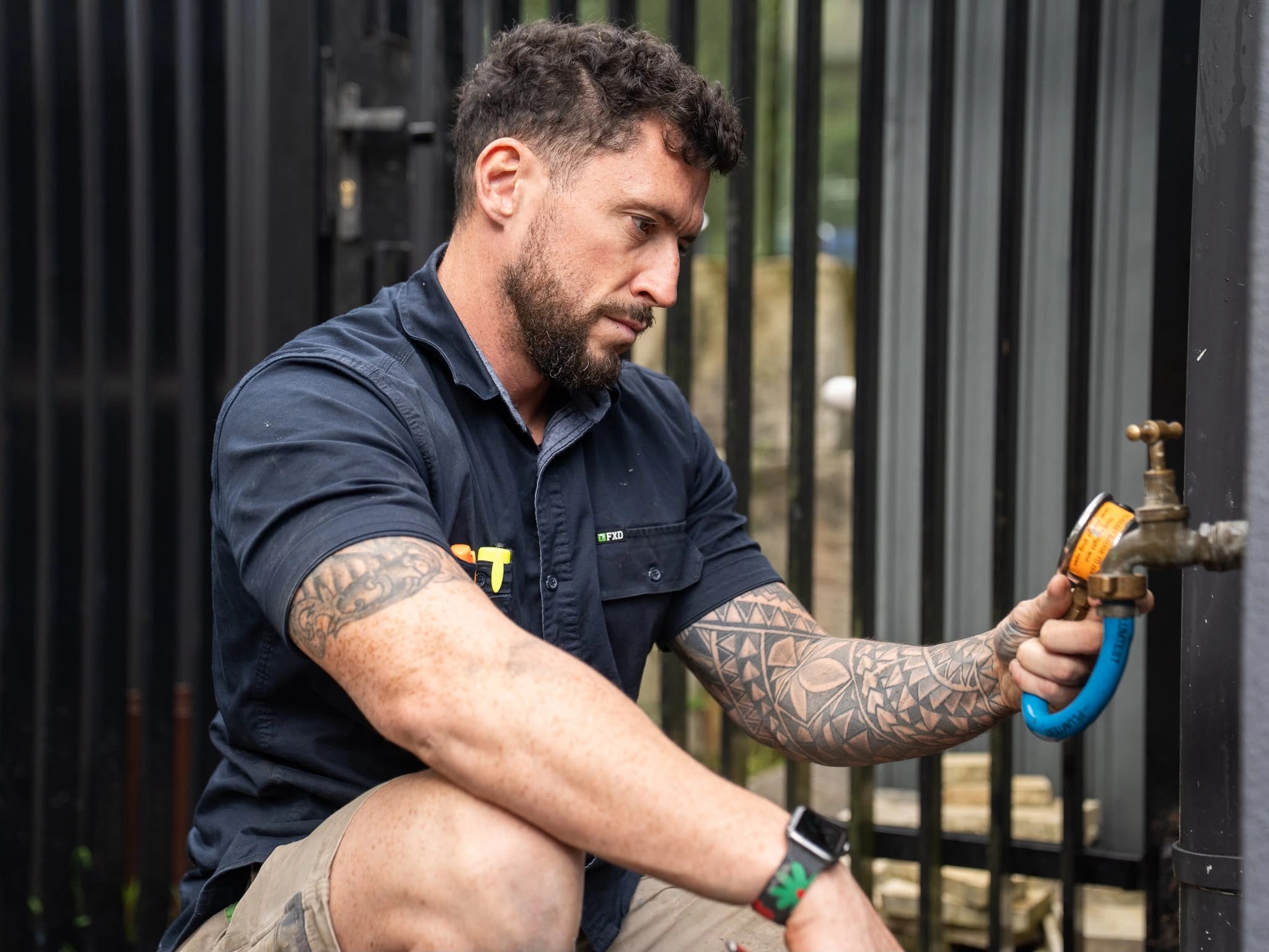 Tom Malone working on a brass exterior tap connection