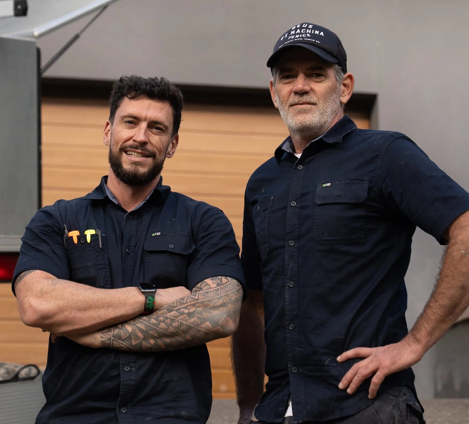 Tom Malone and Mark Donovan standing beside their TotalCare service vehicle